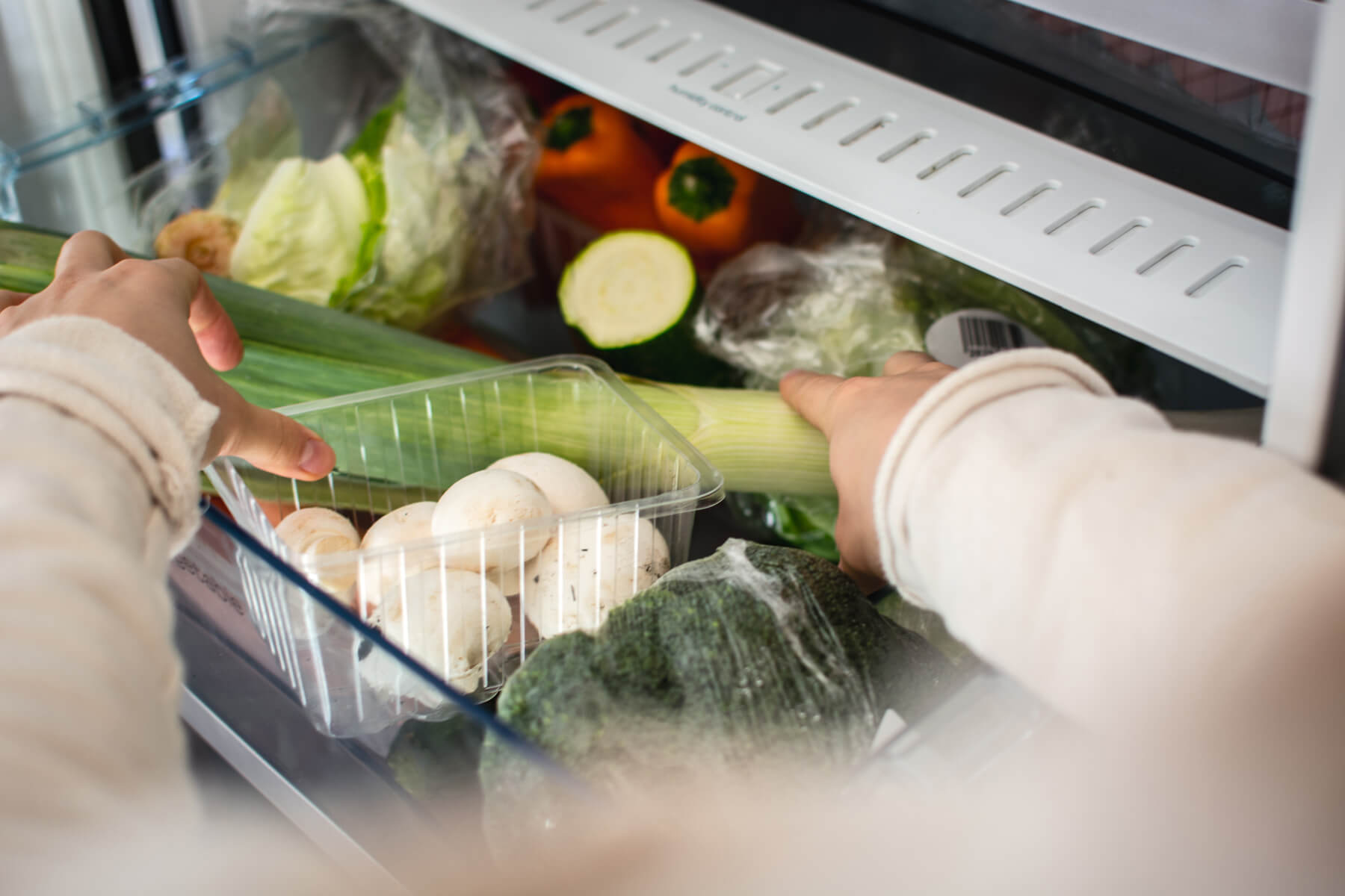 Picking vegetables from a fridge to cook with